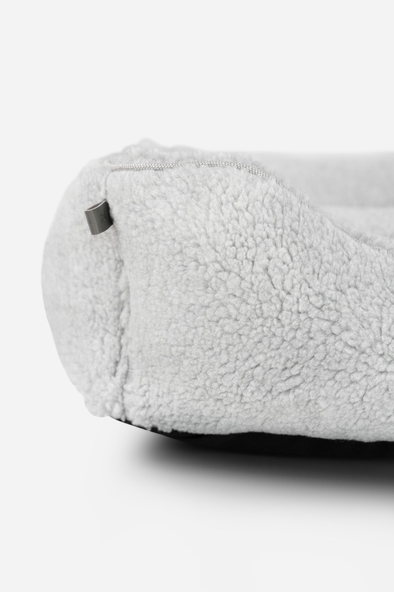 Gray furry sleeper dog bed by Chester & Lee with plush, cozy interior and soft exterior for comfortable pet rest.