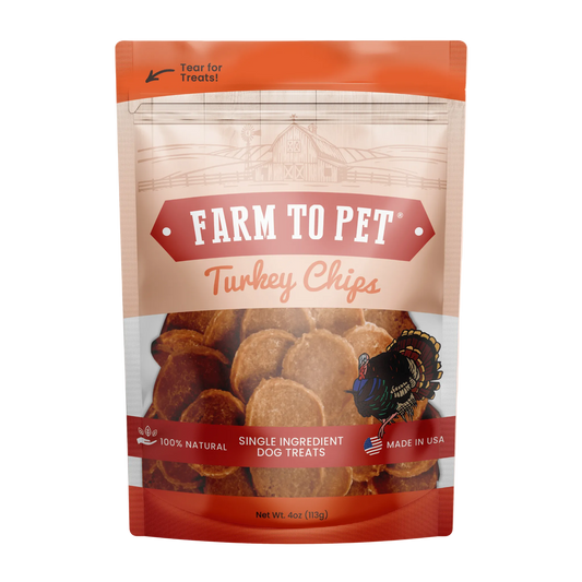 A stand-up pouch of Farm To Pet Turkey Chips dog treats on a plain white background. The packaging is orange and beige with a clear window showing the round turkey-shaped treats inside.