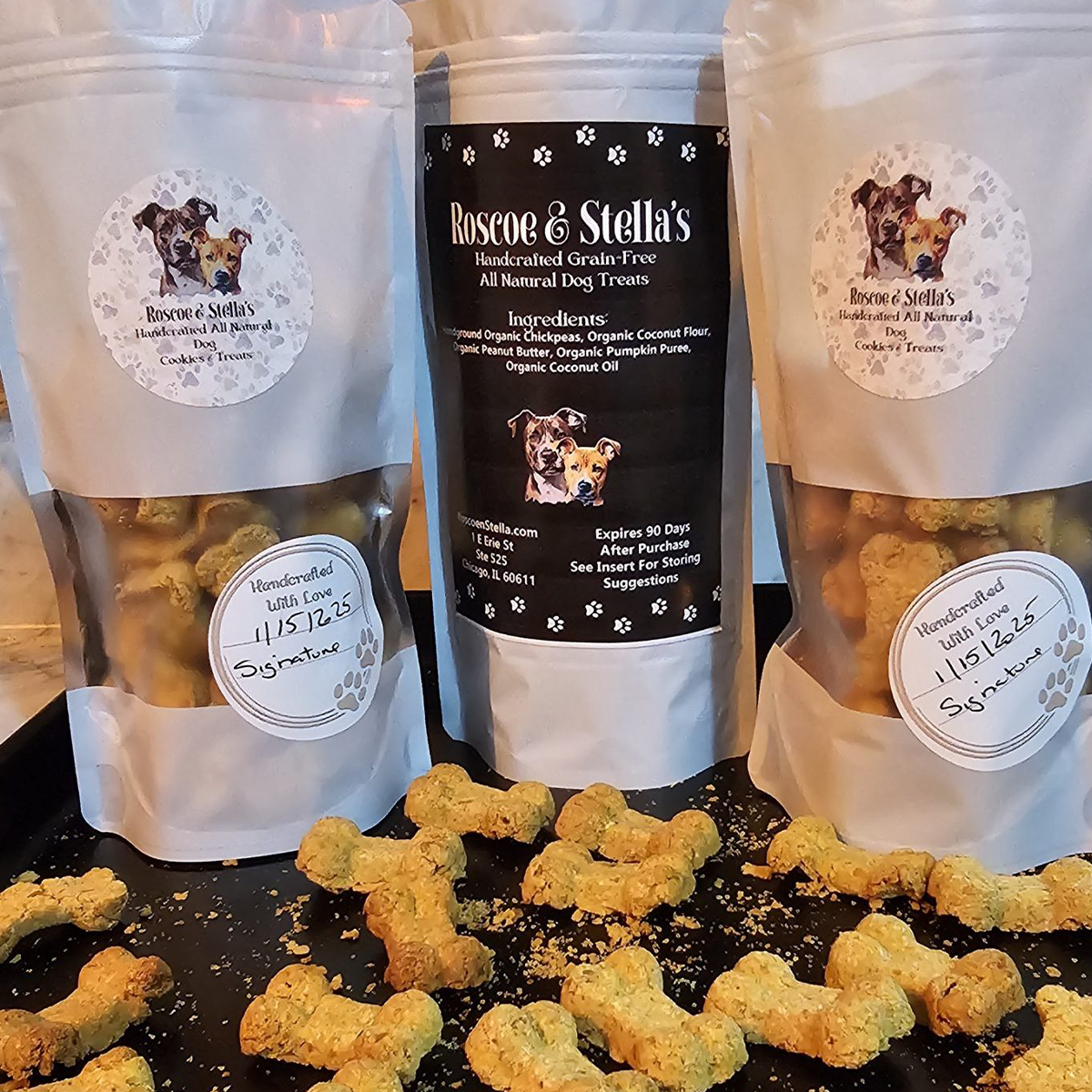 Roscoe & Stella's dog treat packaging with treats on a black surface