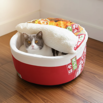 Grey and white cat sleeping inside a plush Japanese ramen cup noodle pet bed on a walnut floor in living room from Paws & Pockets