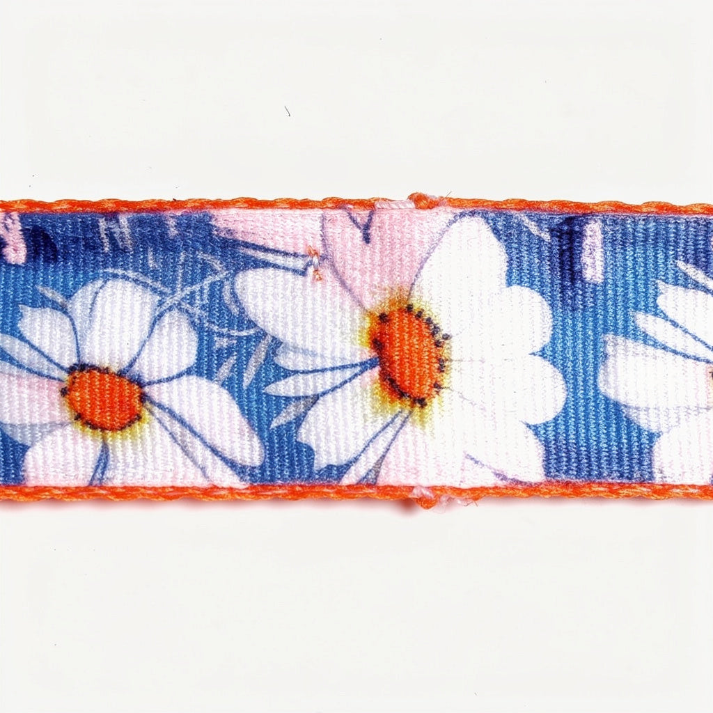Floral ribbon with white flowers and orange centers on a blue background