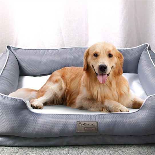 ⁠A happy golden retriever resting comfortably inside a premium grey textured orthopedic dog bed with a plush white cushion from Paws & Pockets