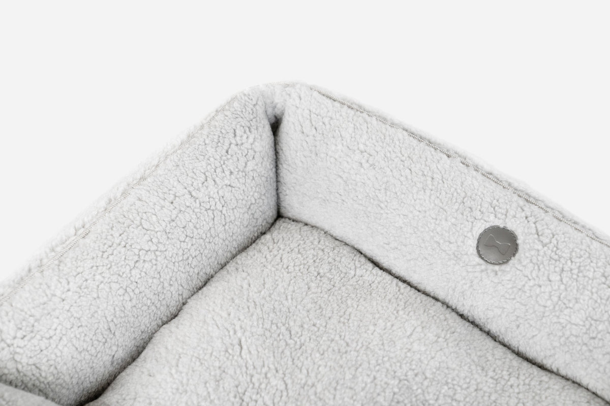 Gray Chester & Lee furry sleeper dog bed with plush interior and soft fabric, designed for comfort and warmth.