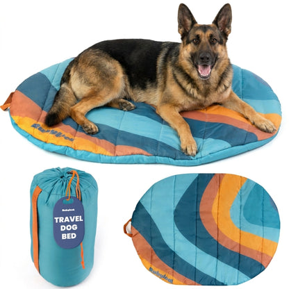 A large German Shepherd resting on a vibrant teal and orange striped Rubyloo packable travel dog bed with a matching storage bag.