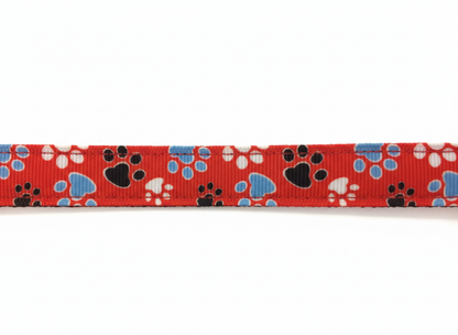 Red adjustable dog collar with blue and white paw prints for small dogs.