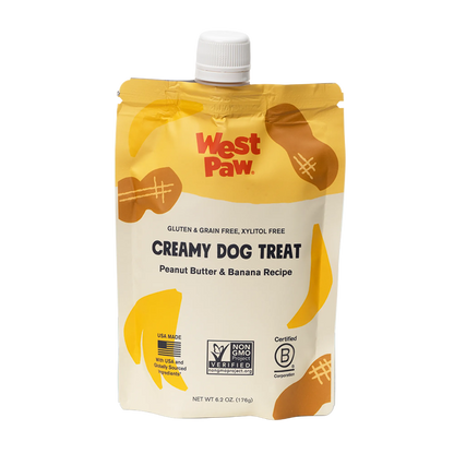 Front view of a 6.2 oz squeezable pouch of West Paw Creamy Dog Treat in Peanut Butter and Banana Recipe, featuring gluten-free, grain-free, and xylitol-free labeling.