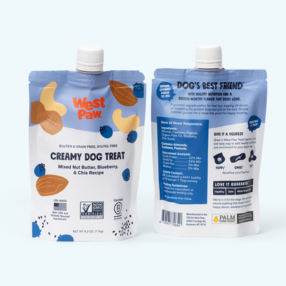 West Paw Nut Butter, Blueberry, and Chia Seed treat being squeezed into a dog treat toy