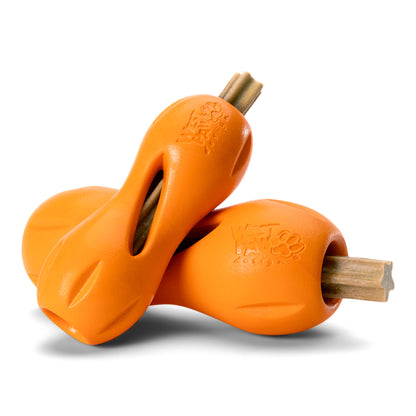 A large dental stick loaded into an orange West Paw Qwizl toy for enrichment chewing